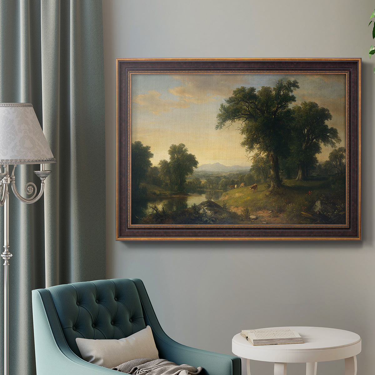 Traditional pastoral landscape painting by Asher Brown Durand in an ornate bronzed mahogany wood frame displayed in a bright interior setting.