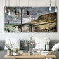Three-panel canvas wall art featuring sunset beach with glowing sky, displayed in a modern living room above seating.
