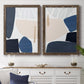 Set of two walnut barnwood framed canvas prints depicting a coordinated art pair of large navy cream and beige organic geometric shapes rendered as minimalist color-block abstracts above a dining room sideboard.