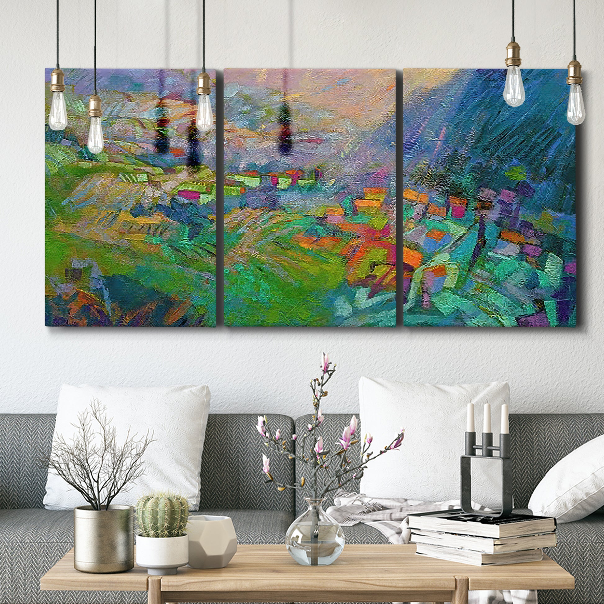 Three-panel canvas wall art featuring embracing landscape with warm tones, displayed in a modern living room above seating.