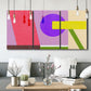 Three-panel canvas wall art featuring bold geometric color abstraction, displayed in a modern living room above seating.