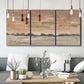 Three-panel canvas wall art featuring soft early evening landscape light, displayed in a modern living room above seating.