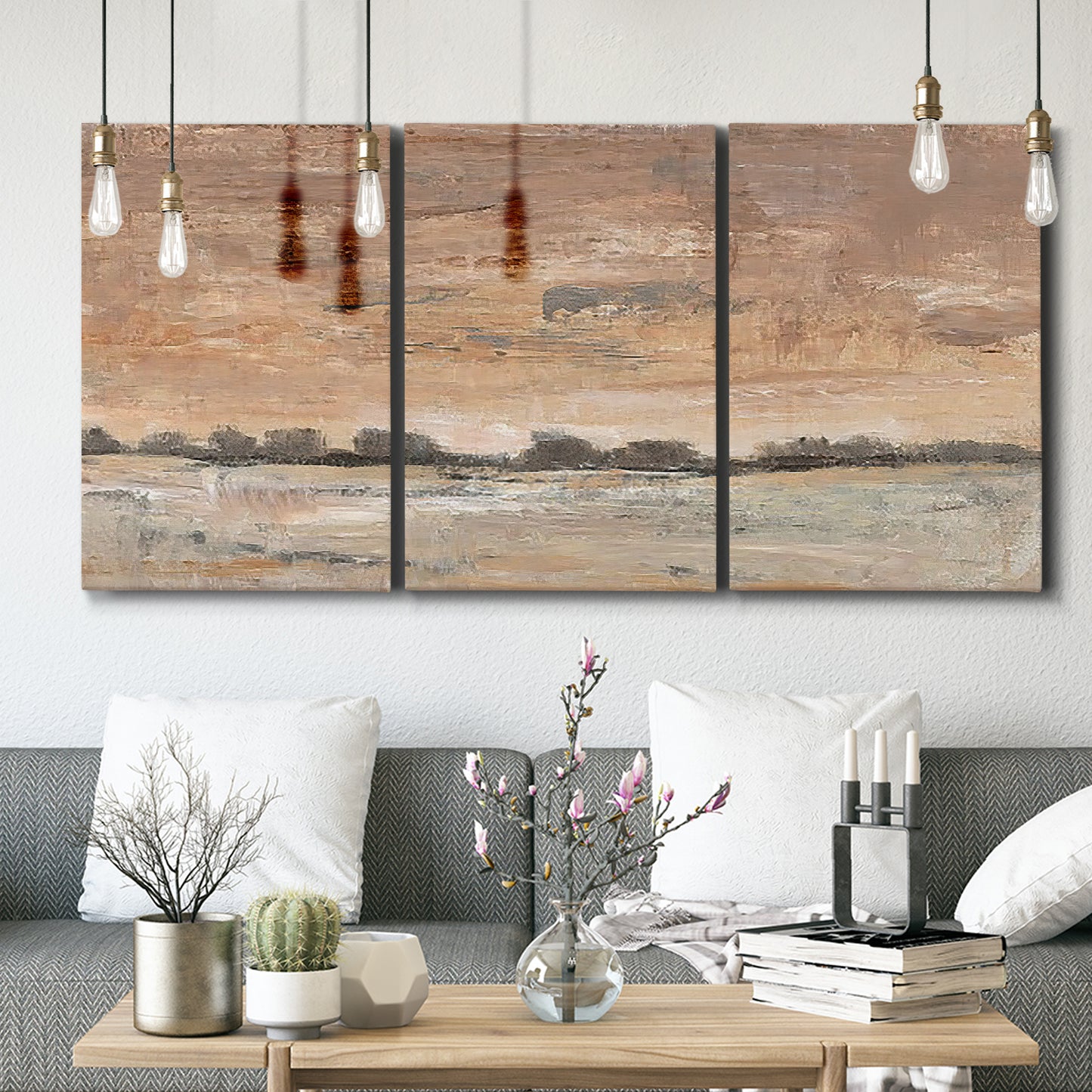 Three-panel canvas wall art featuring soft early evening landscape light, displayed in a modern living room above seating.