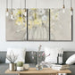 Three-panel canvas wall art featuring vintage floral abstract composition, displayed in a modern living room above seating.