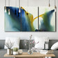 Three-panel canvas wall art featuring soft abstract mask like forms, displayed in a modern living room above seating.