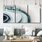 Three-panel canvas wall art featuring abstract coastal shell forms, displayed in a modern living room above seating.