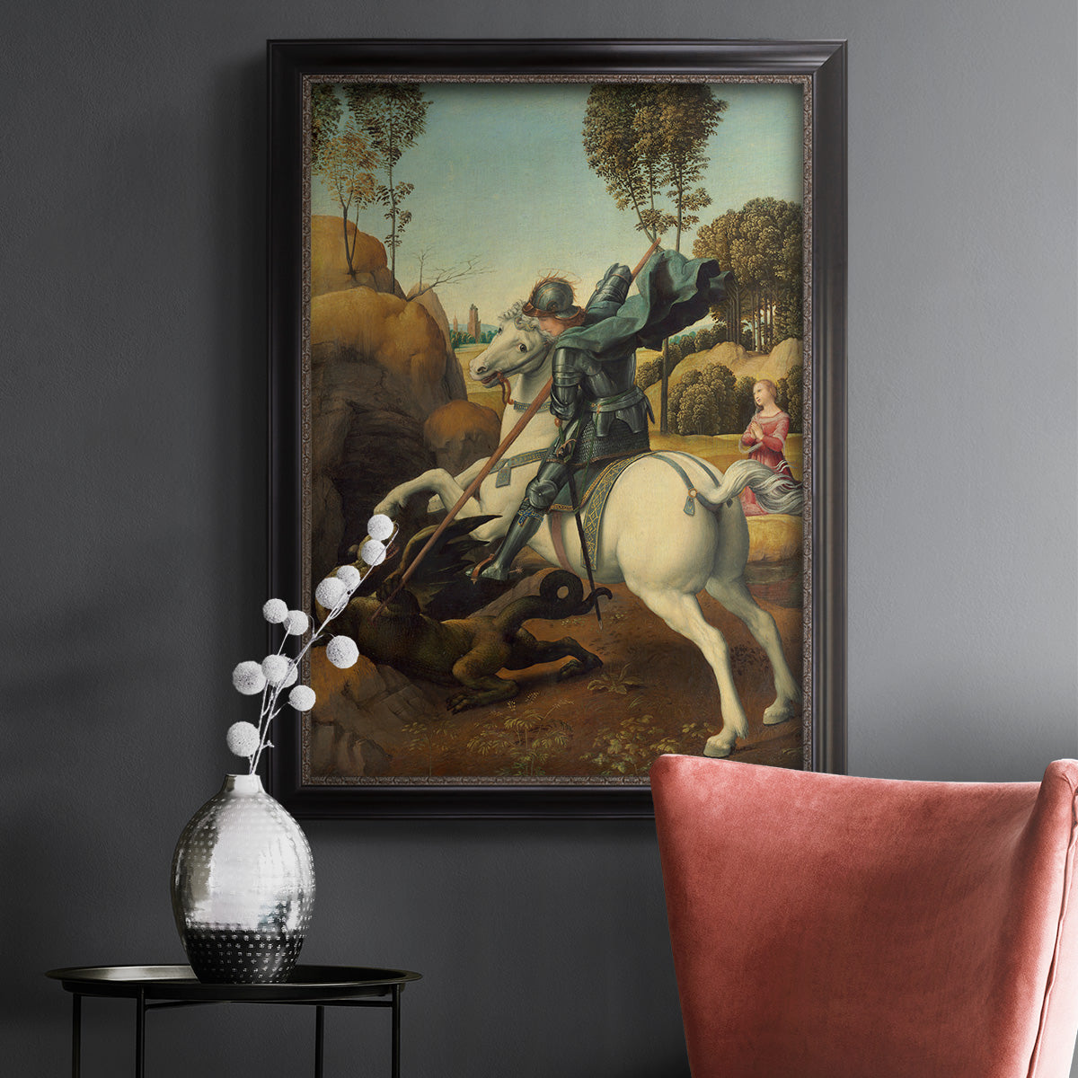 Religious painting of Saint George slaying the dragon by Raphael in an ornate black frame with gilded inner detail displayed in a dark-toned interior setting.