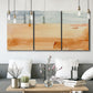 Three-panel canvas wall art featuring minimal horizon with soft blue tones, displayed in a modern living room above seating.