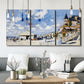 Three-panel canvas wall art featuring beach boardwalk with figures, displayed in a modern living room above seating.