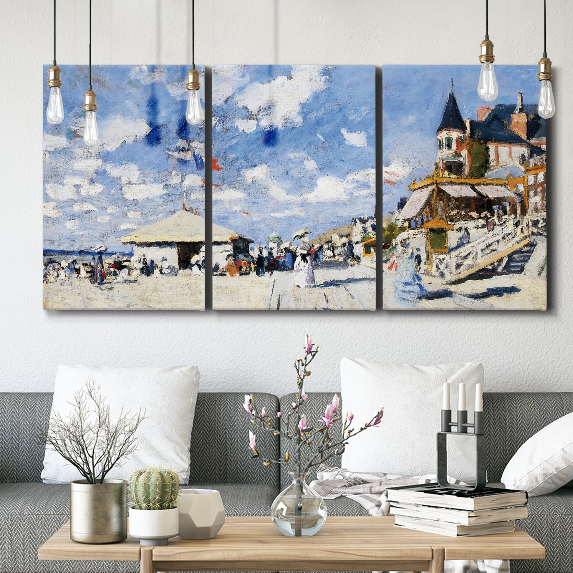 Three-panel canvas wall art featuring beach boardwalk with figures, displayed in a modern living room above seating.