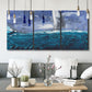 Three-panel canvas wall art featuring sailboats moving across water, displayed in a modern living room above seating.