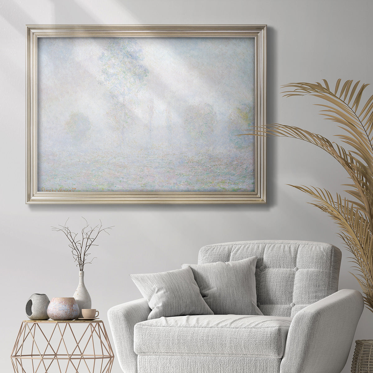 Impressionist atmospheric landscape in morning haze by Claude Monet in an ornate champagne frame displayed in a bright interior setting.