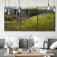 Three-panel canvas wall art featuring winding path through rolling hills, displayed in a modern living room above seating.