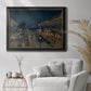 Impressionist nighttime Paris street scene by Camille Pissarro in an ornate black frame with gilded inner detail displayed in a bright interior setting.
