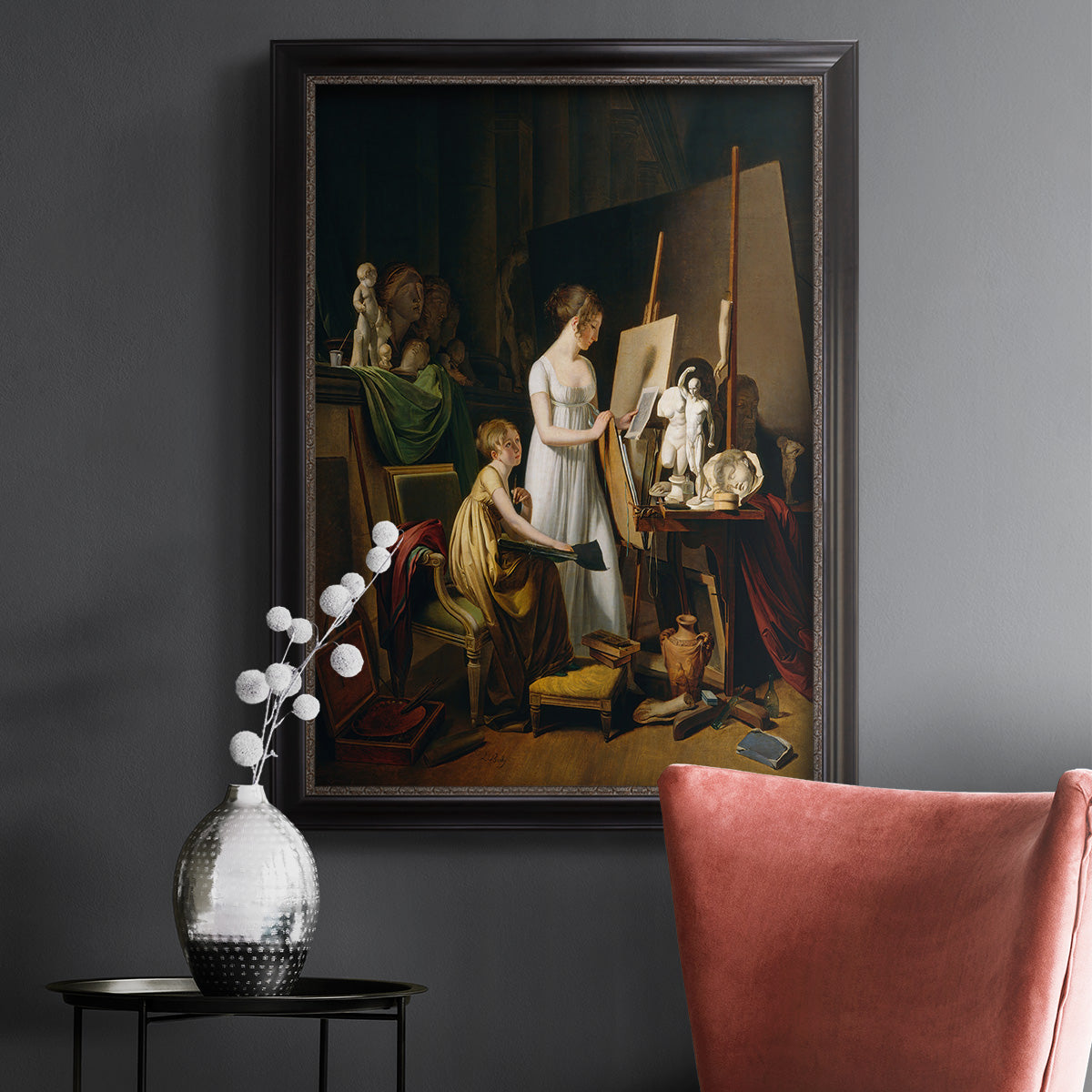 Classical interior painting of an artist at work by Louis-Leopold Boilly in an ornate black frame with gilded inner detail displayed in a dark-toned interior setting.