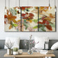 Three-panel canvas wall art featuring layered floral botanical impressions, displayed in a modern living room above seating.