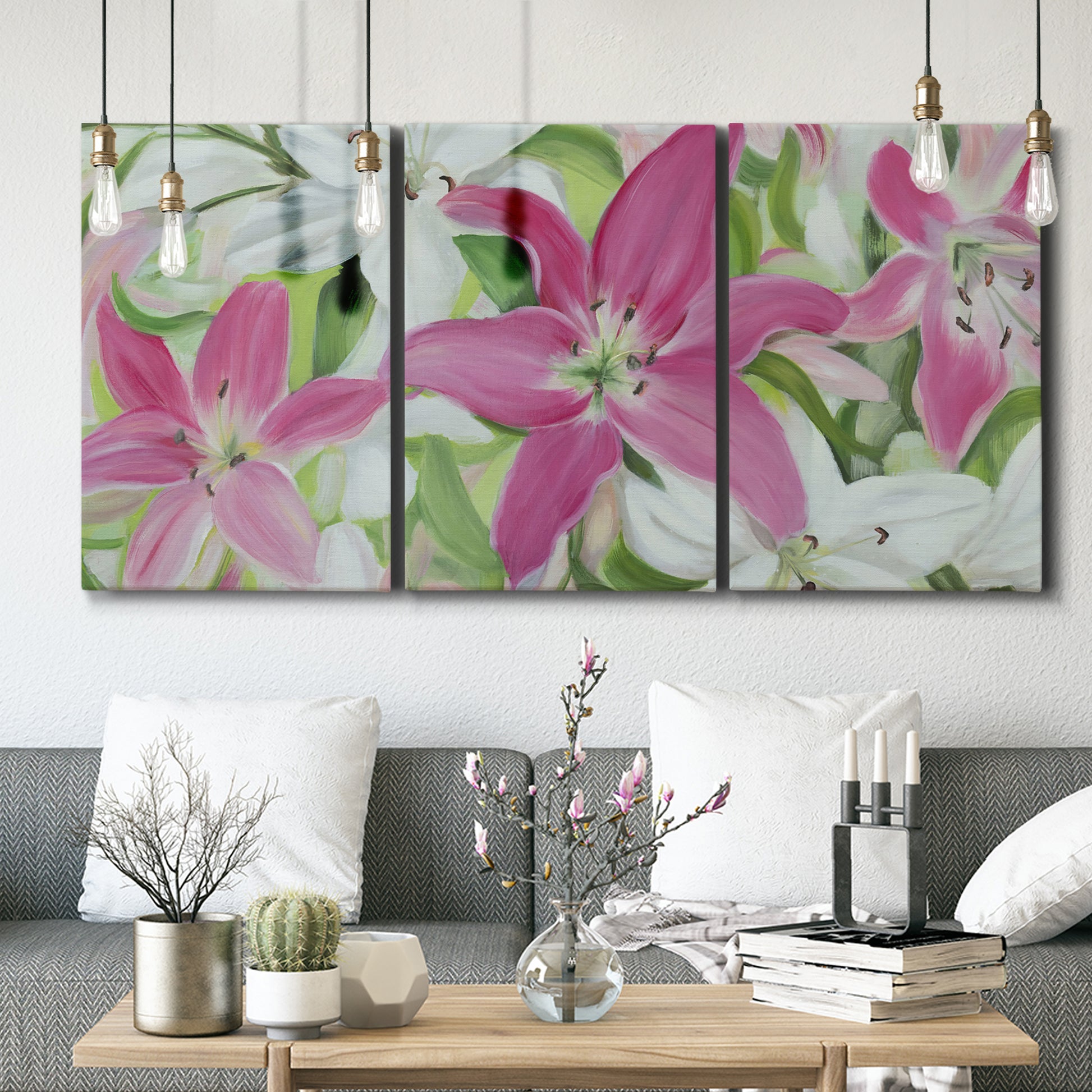 Three-panel canvas wall art featuring pink and white lilies in bloom, displayed in a modern living room above seating.