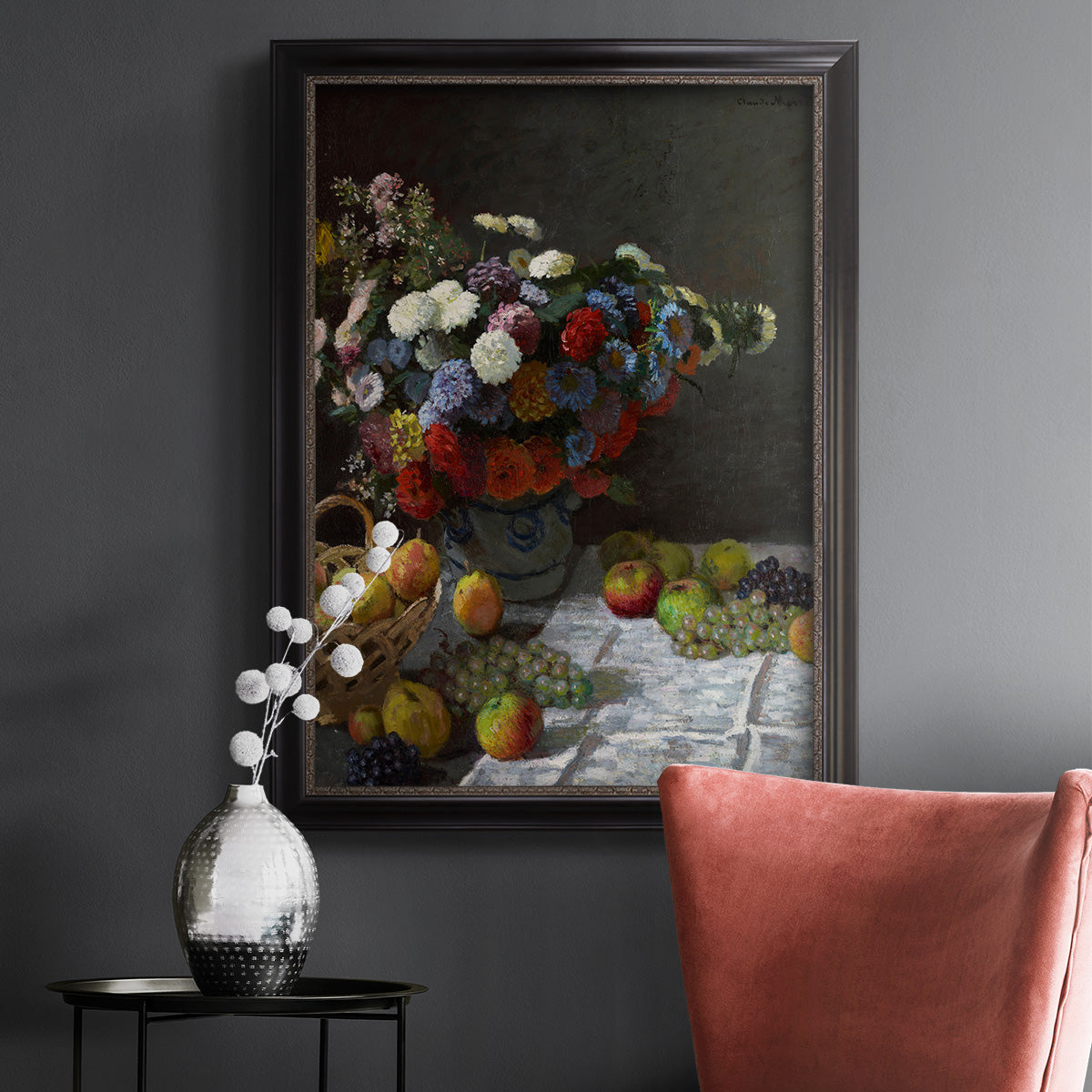 Impressionist floral still life painting by Claude Monet in an ornate black frame with gilded inner detail displayed in a dark-toned interior setting.