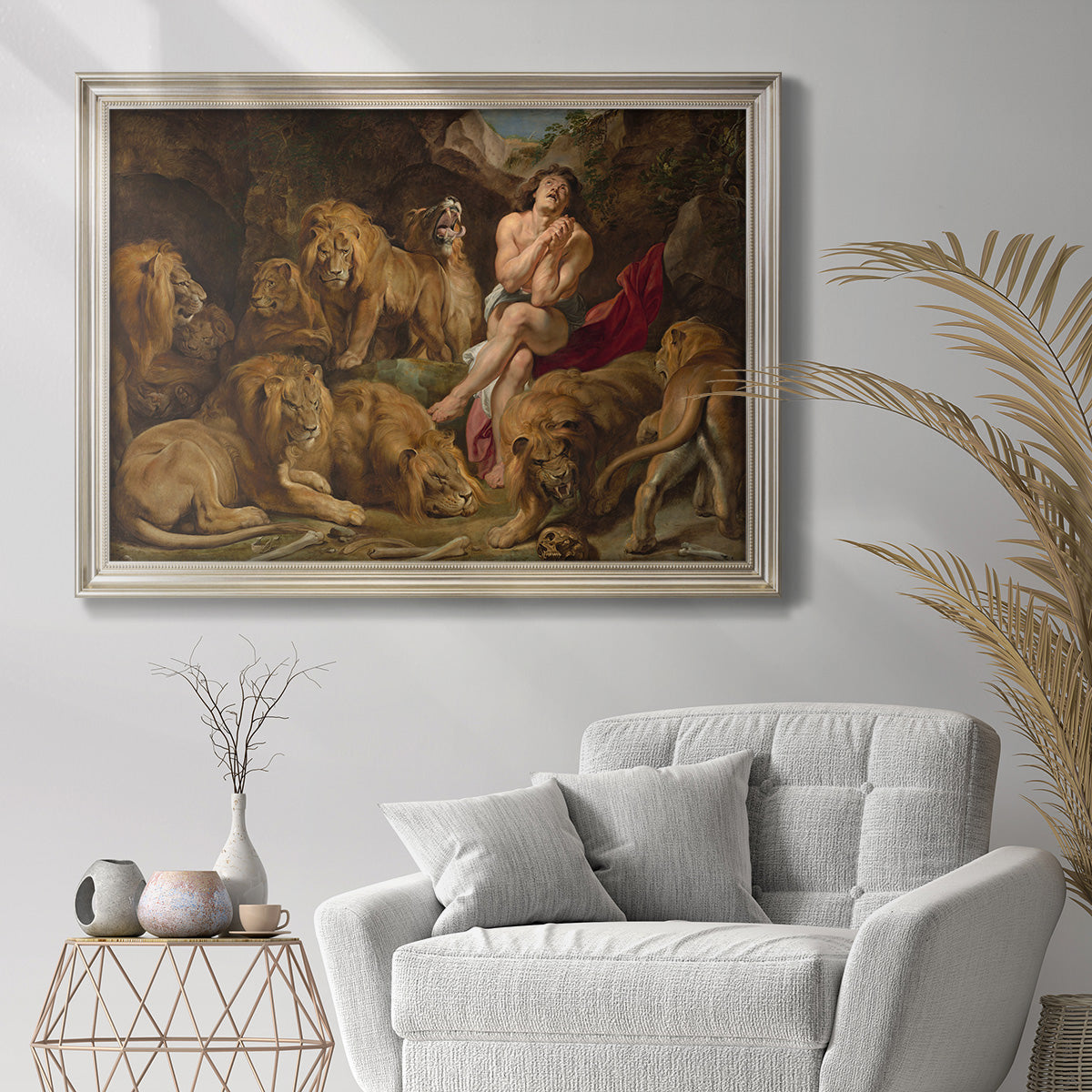 Dramatic biblical painting of Daniel with lions by Peter Paul Rubens in an ornate champagne frame displayed in a bright interior setting.