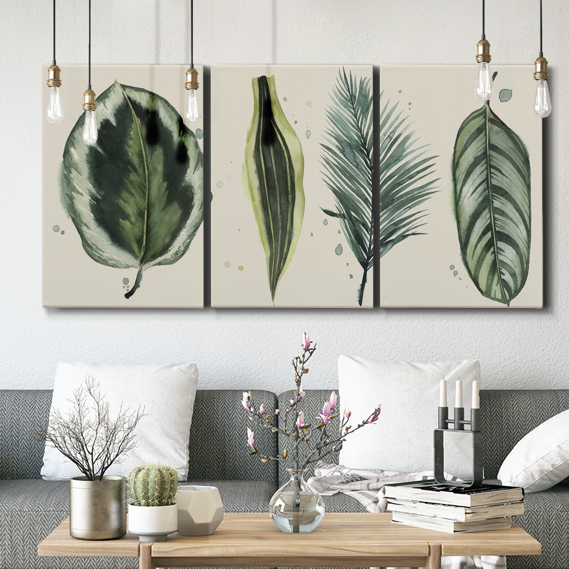 Three-panel canvas wall art featuring botanical palm leaf illustration, displayed in a modern living room above seating.