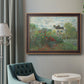 Impressionist garden landscape at Argenteuil by Claude Monet in an ornate bronzed mahogany wood frame displayed in a bright interior setting.