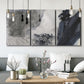 Three-panel canvas wall art featuring dark abstract atmospheric landscape, displayed in a modern living room above seating.