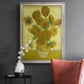 Impressionist sunflower still life painting by Vincent van Gogh in an ornate champagne frame displayed in a dark-toned interior setting.