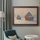 Impressionist winter haystack scene by Claude Monet in an ornate bronzed mahogany wood frame displayed in a bright interior setting.