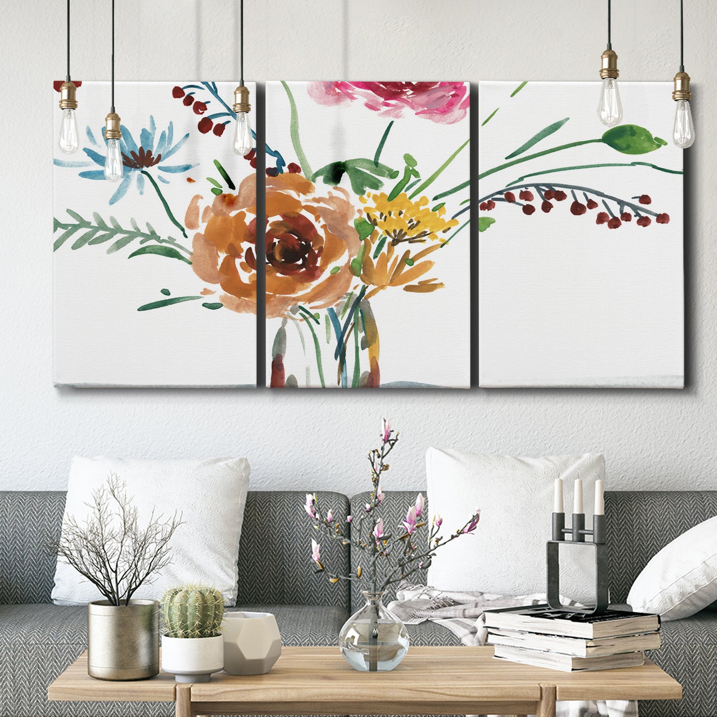Three-panel canvas wall art featuring vibrant floral bouquet, displayed in a modern living room above seating.