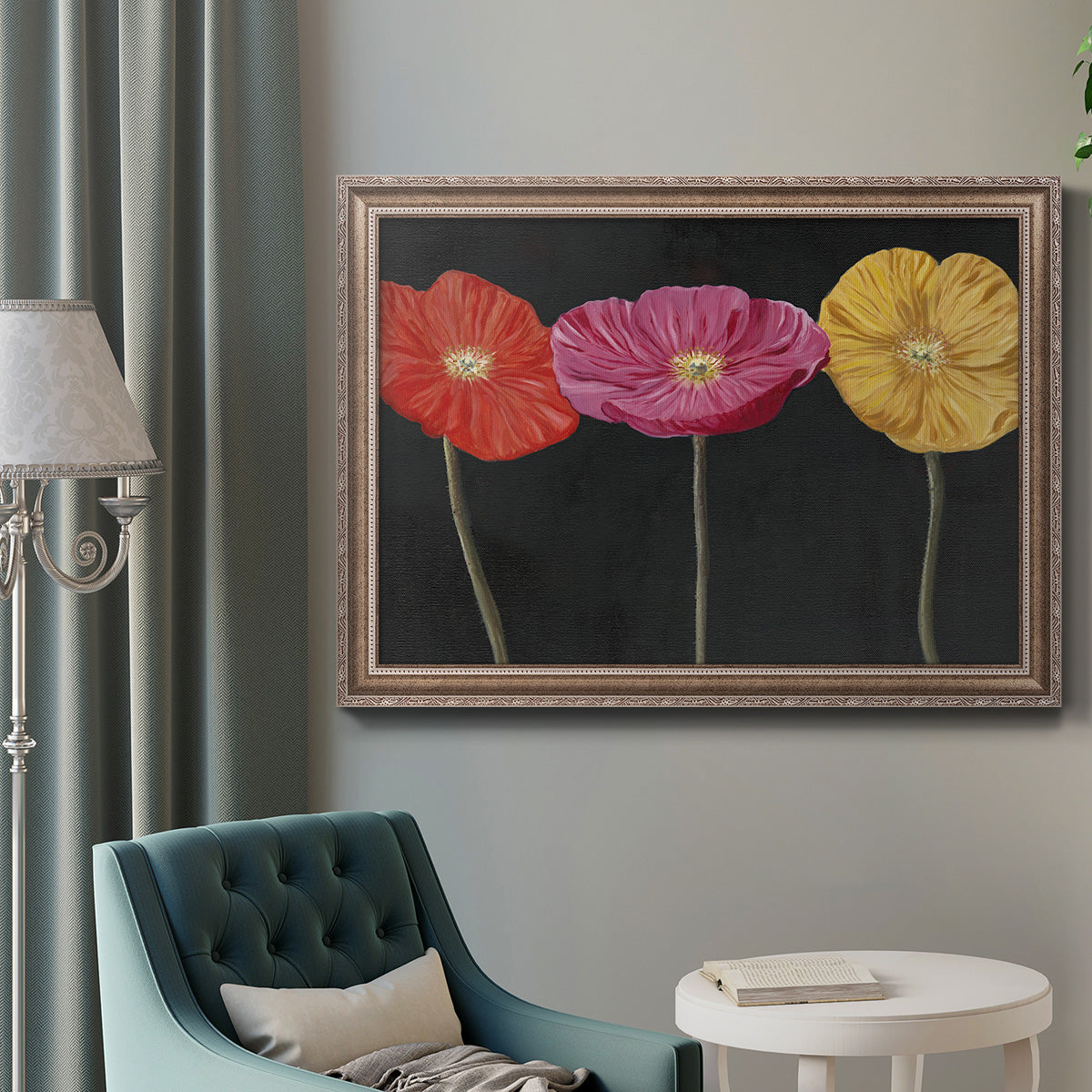 Contemporary poppy flower artwork in an ornate traditional silver frame displayed in a neutral interior setting.