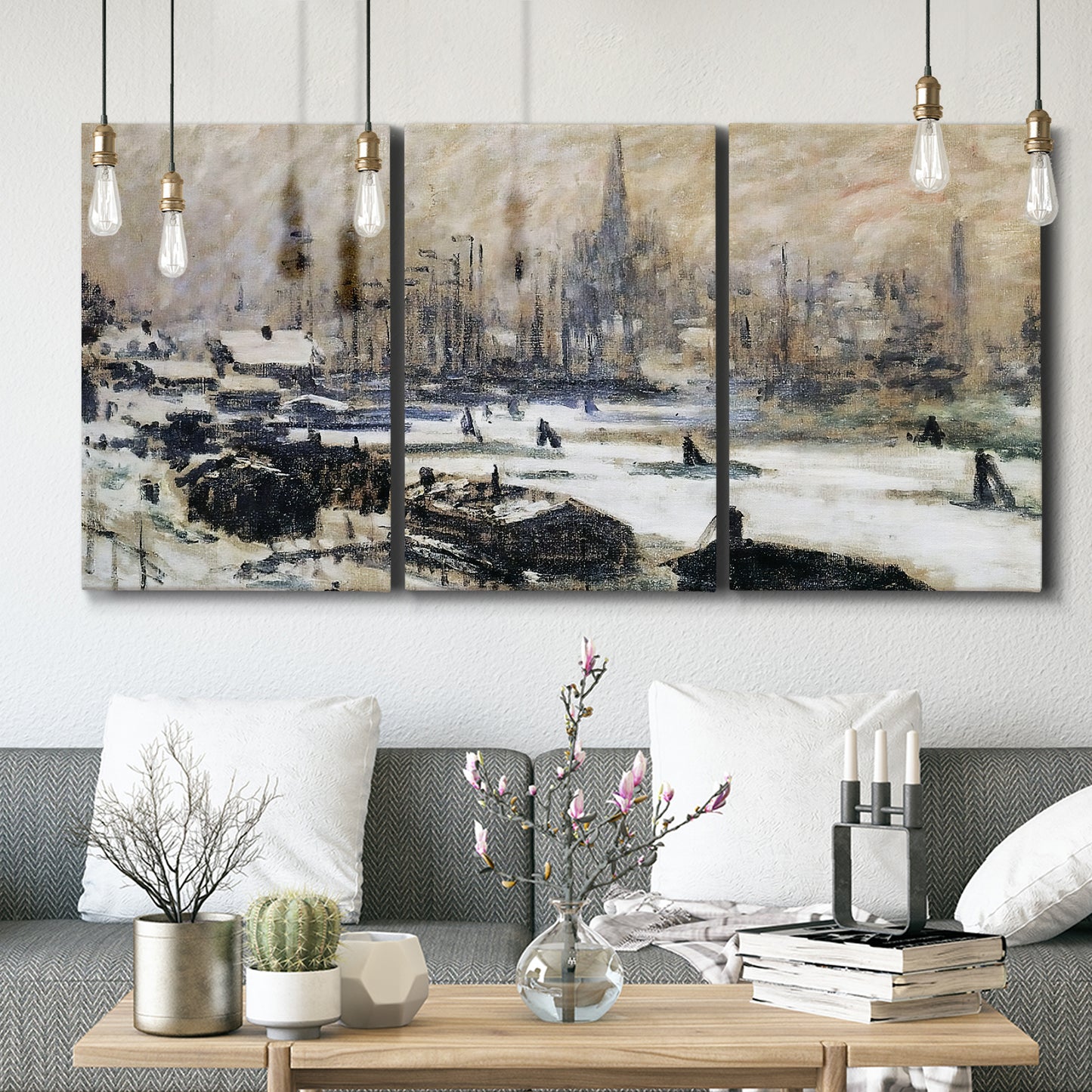 Three-panel canvas wall art featuring snowy village road in winter, displayed in a modern living room above seating.