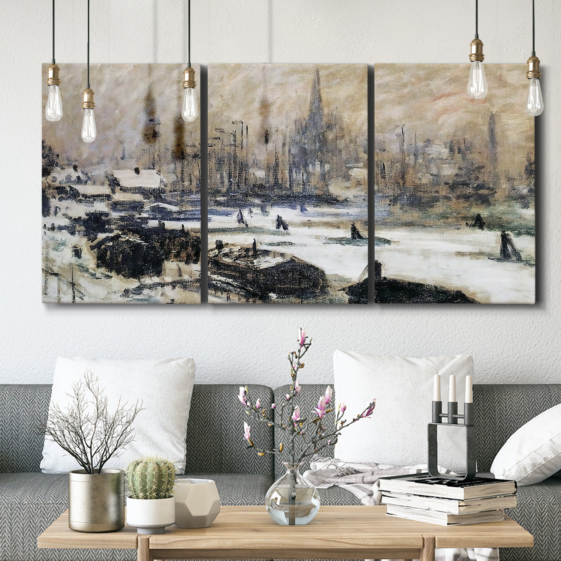 Three-panel canvas wall art featuring snowy village road in winter, displayed in a modern living room above seating.