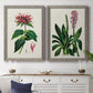 Set of two gray barnwood framed canvas prints depicting a coordinated art pair of colorful flowering plant specimens rendered as antique botanical plate illustrations above a dining room sideboard.