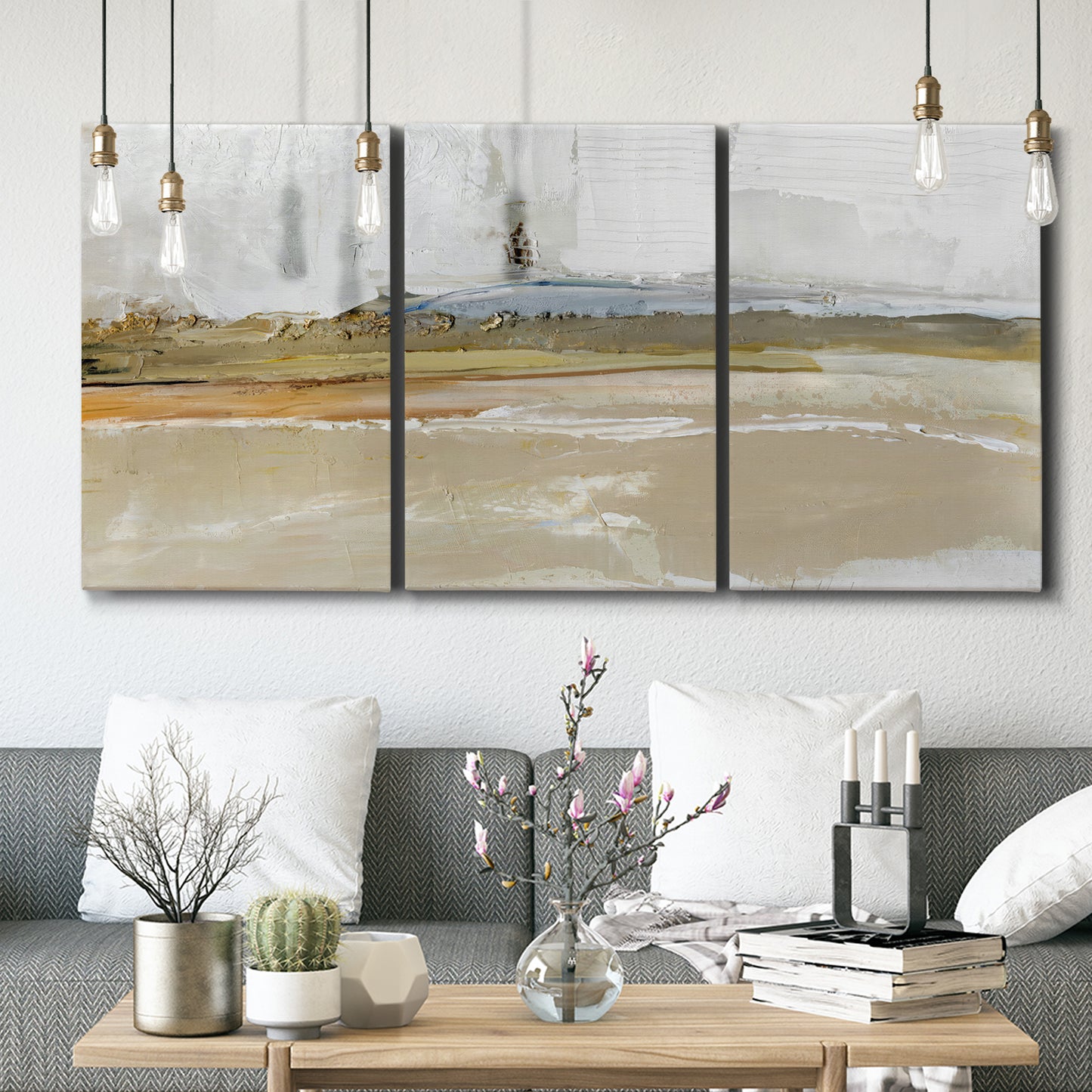 Three-panel canvas wall art featuring golden hour light over landscape, displayed in a modern living room above seating.