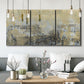 Three-panel canvas wall art featuring gold toned abstract horizon, displayed in a modern living room above seating.