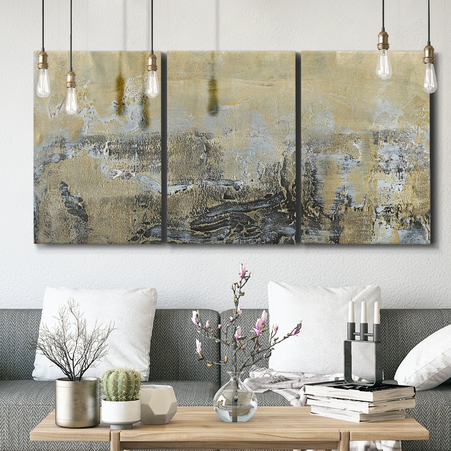 Three-panel canvas wall art featuring gold toned abstract horizon, displayed in a modern living room above seating.