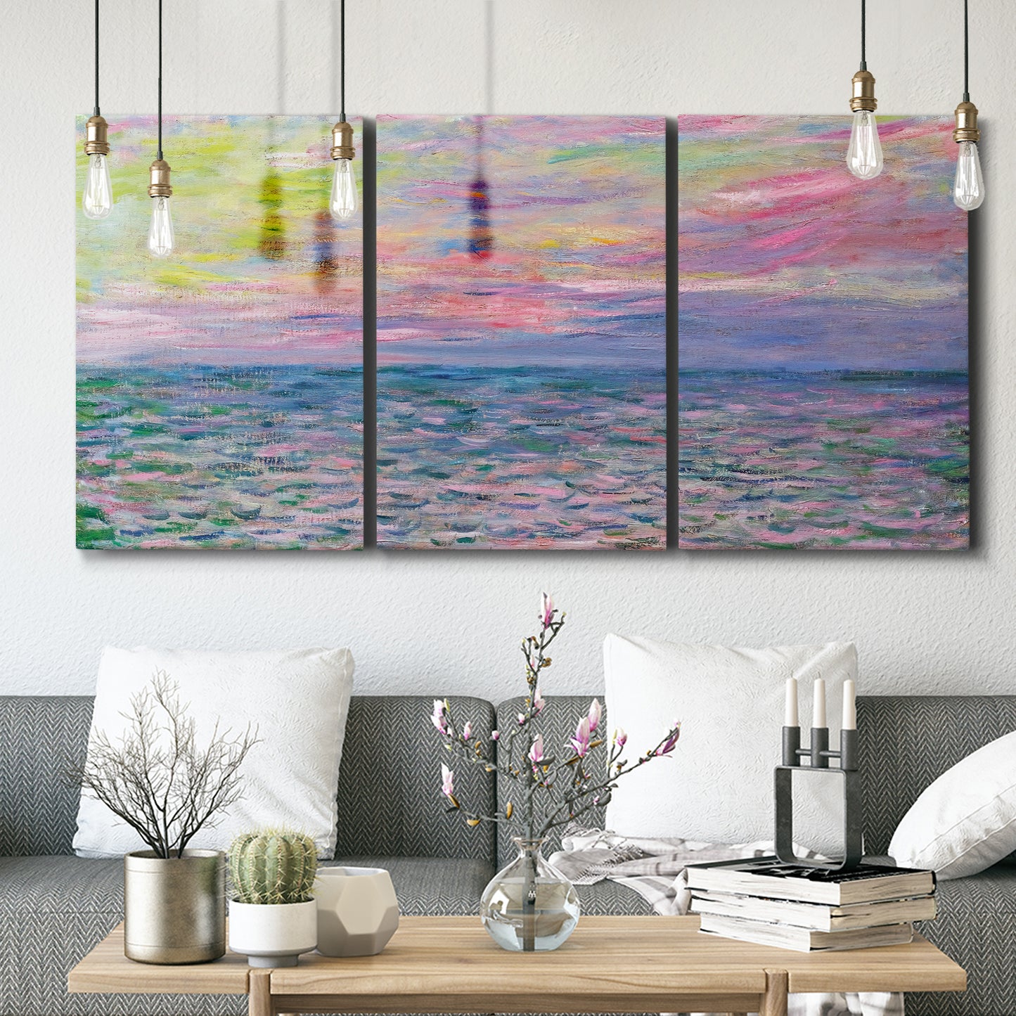Three-panel canvas wall art featuring sunset reflections across calm sea, displayed in a modern living room above seating.