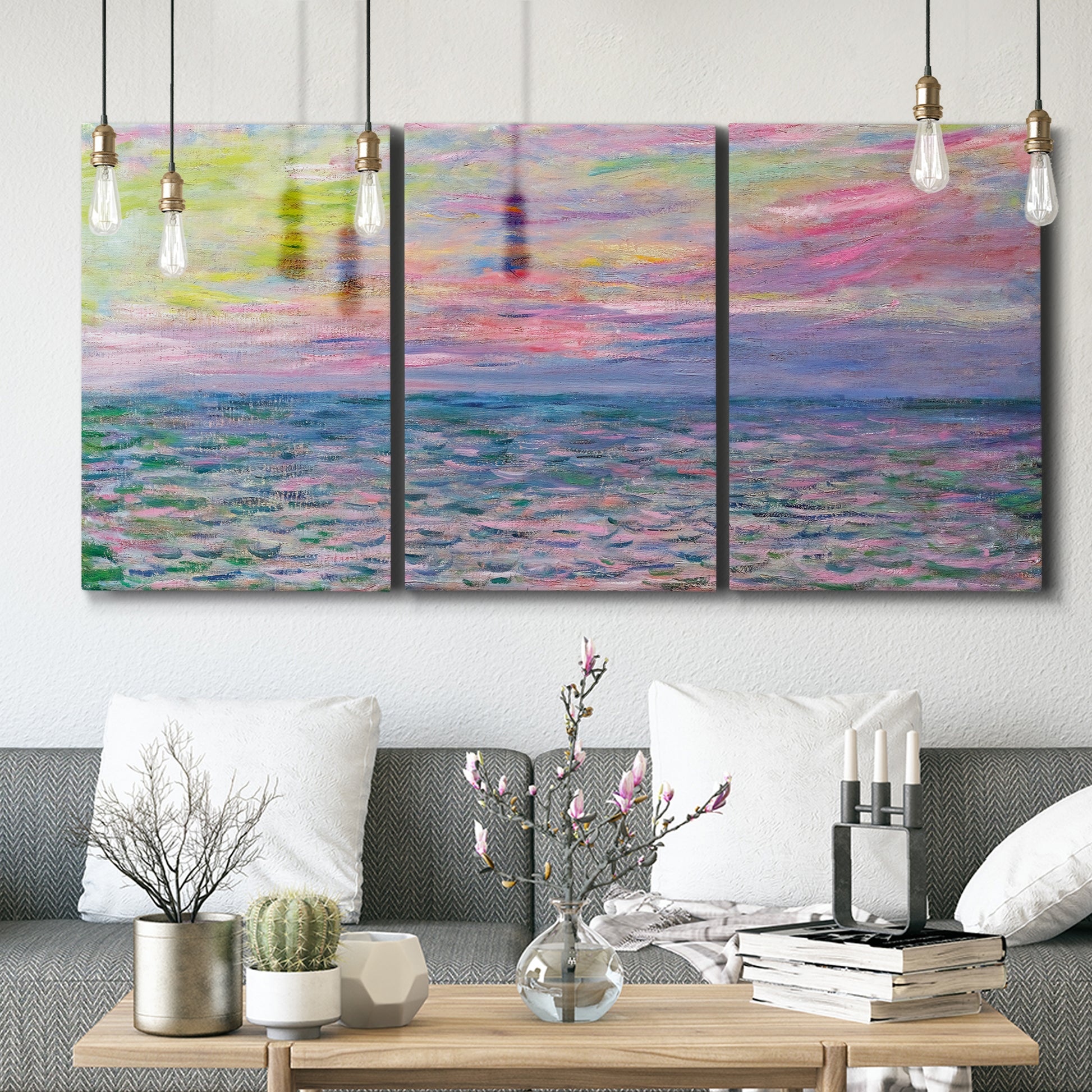 Three-panel canvas wall art featuring sunset reflections across calm sea, displayed in a modern living room above seating.