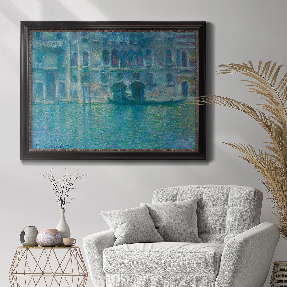 Impressionist Venetian palace waterfront scene by Claude Monet in an ornate black frame with gilded inner detail displayed in a bright interior setting.