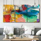 Three-panel canvas wall art featuring layered abstract observational color blocks, displayed in a modern living room above seating.