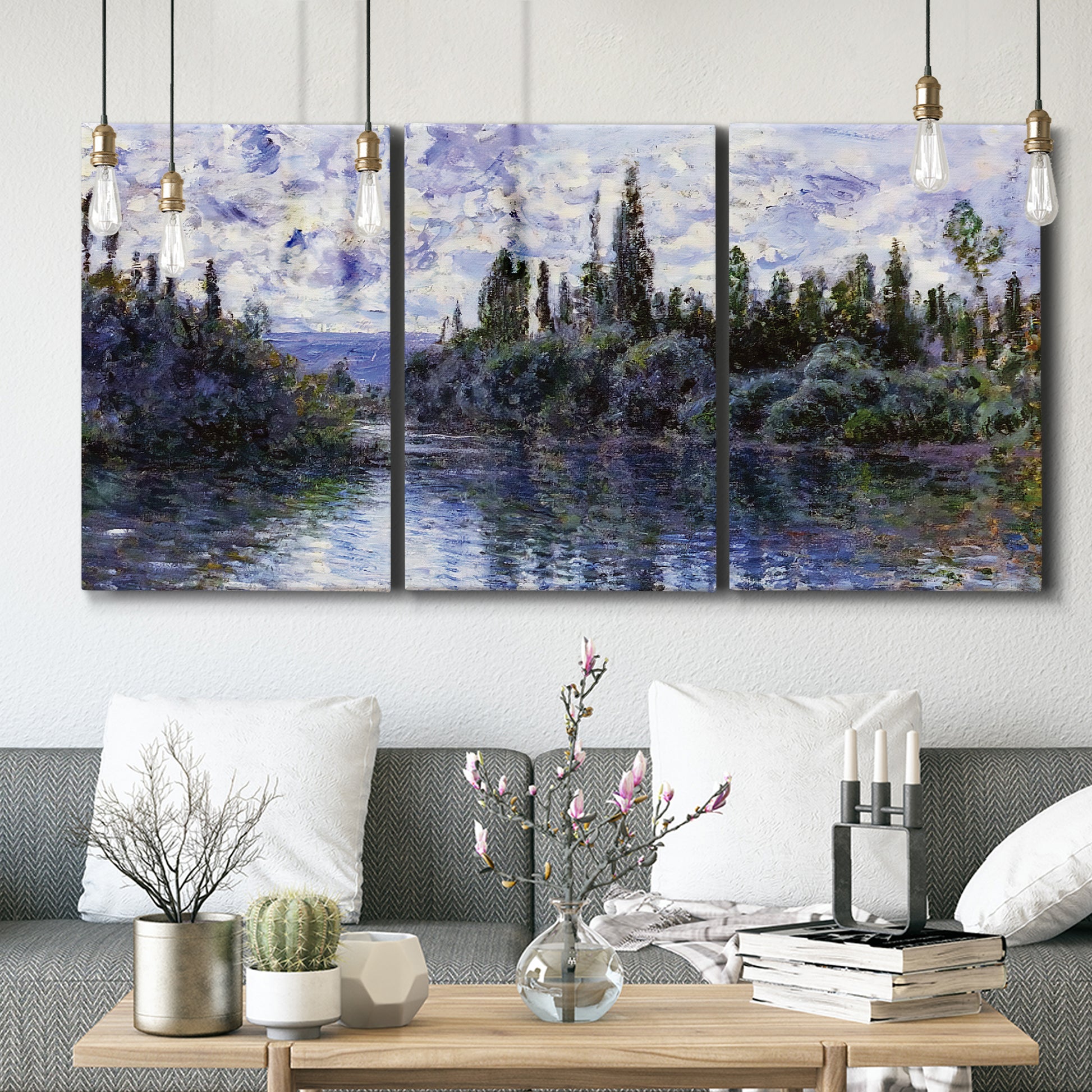 Three-panel canvas wall art featuring quiet river bend near village, displayed in a modern living room above seating.