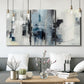 Three-panel canvas wall art featuring cool abstract winter color wash, displayed in a modern living room above seating.