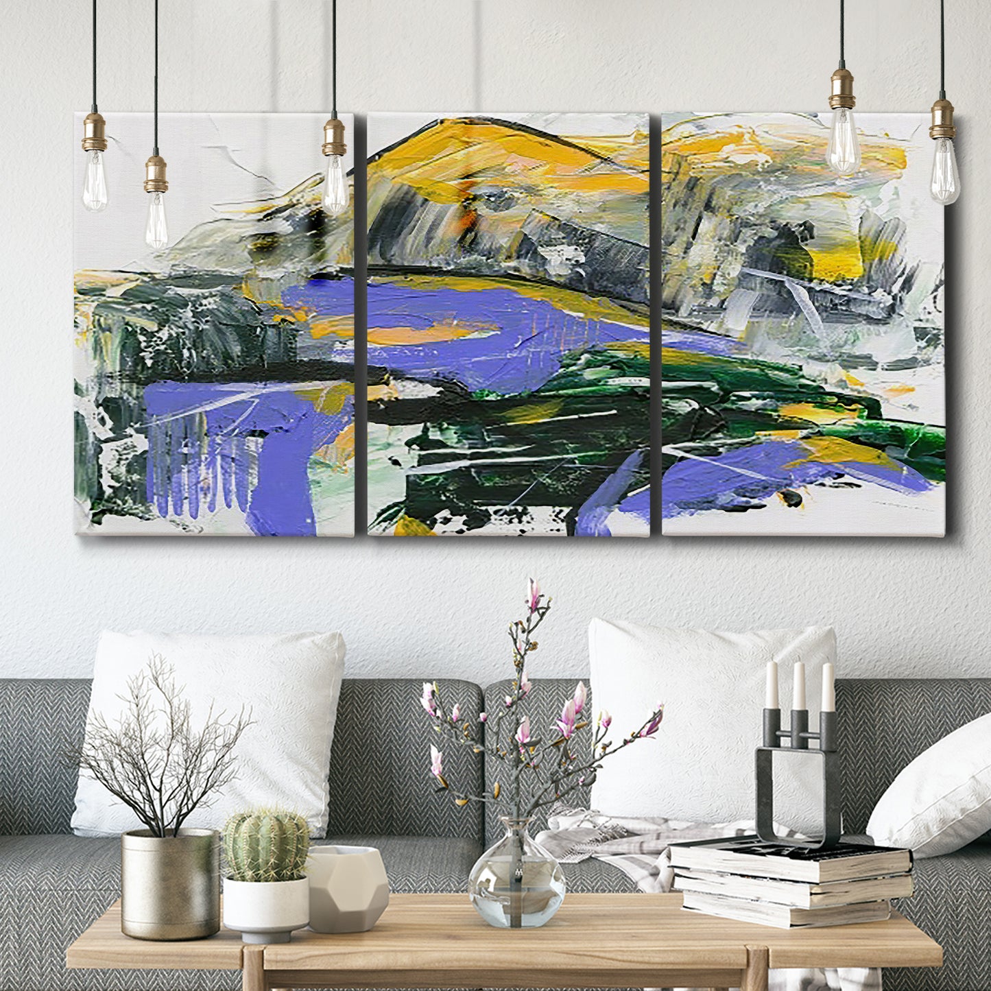 Three-panel canvas wall art featuring quiet abstract mountain silhouette, displayed in a modern living room above seating.