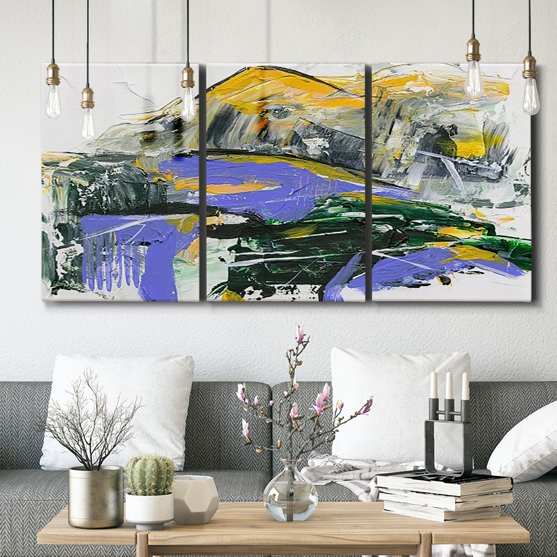 Three-panel canvas wall art featuring quiet abstract mountain silhouette, displayed in a modern living room above seating.