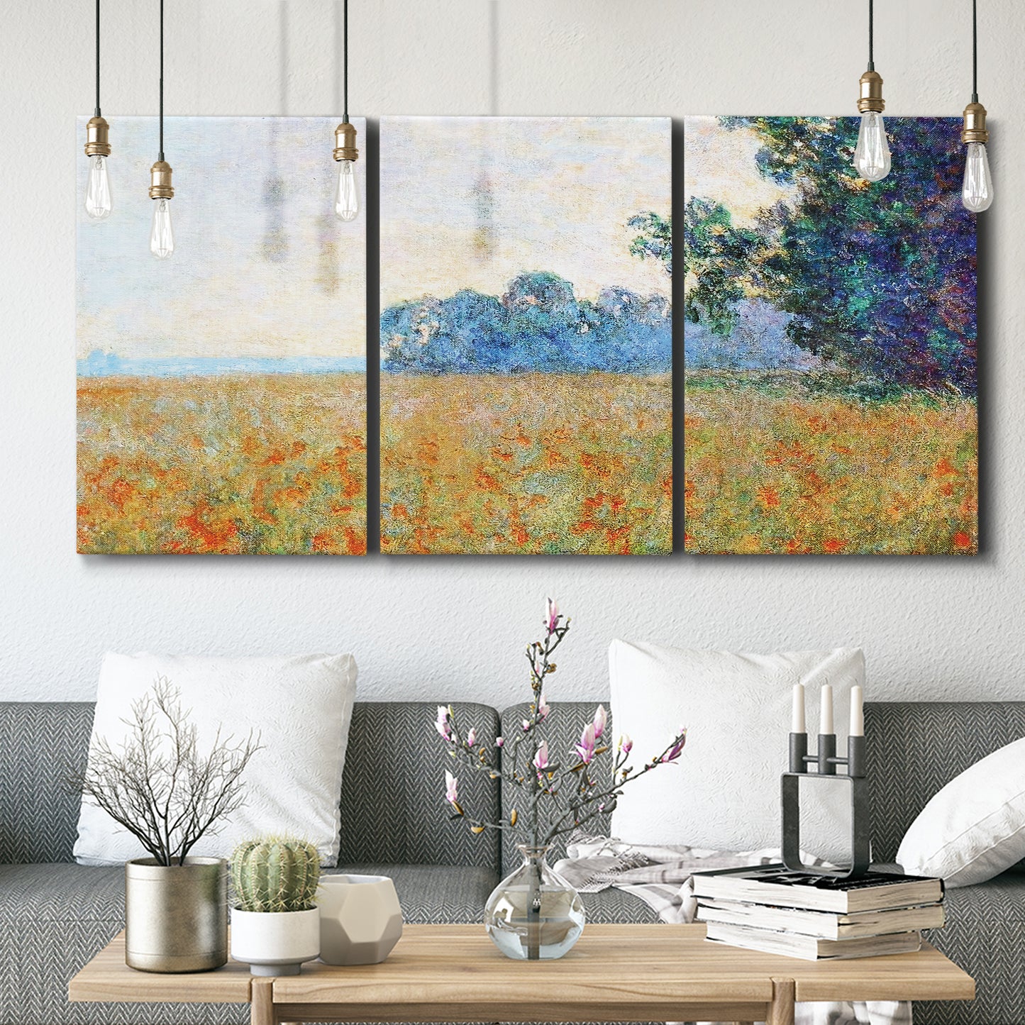 Three-panel canvas wall art featuring oat field with scattered poppies, displayed in a modern living room above seating.