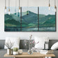 Three-panel canvas wall art featuring muted mountain range in grey tones, displayed in a modern living room above seating.
