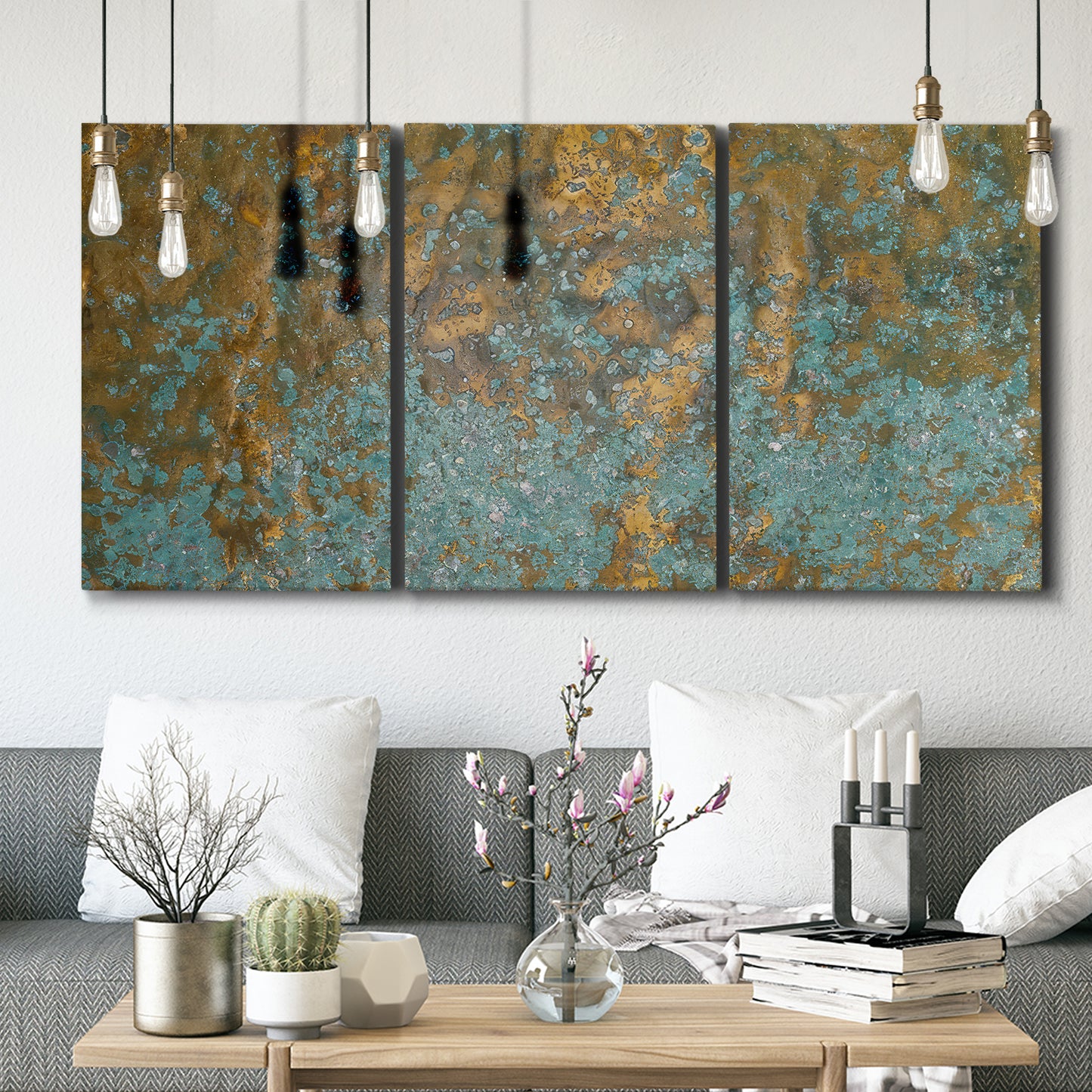 Three-panel canvas wall art featuring earthy copper toned abstract, displayed in a modern living room above seating.