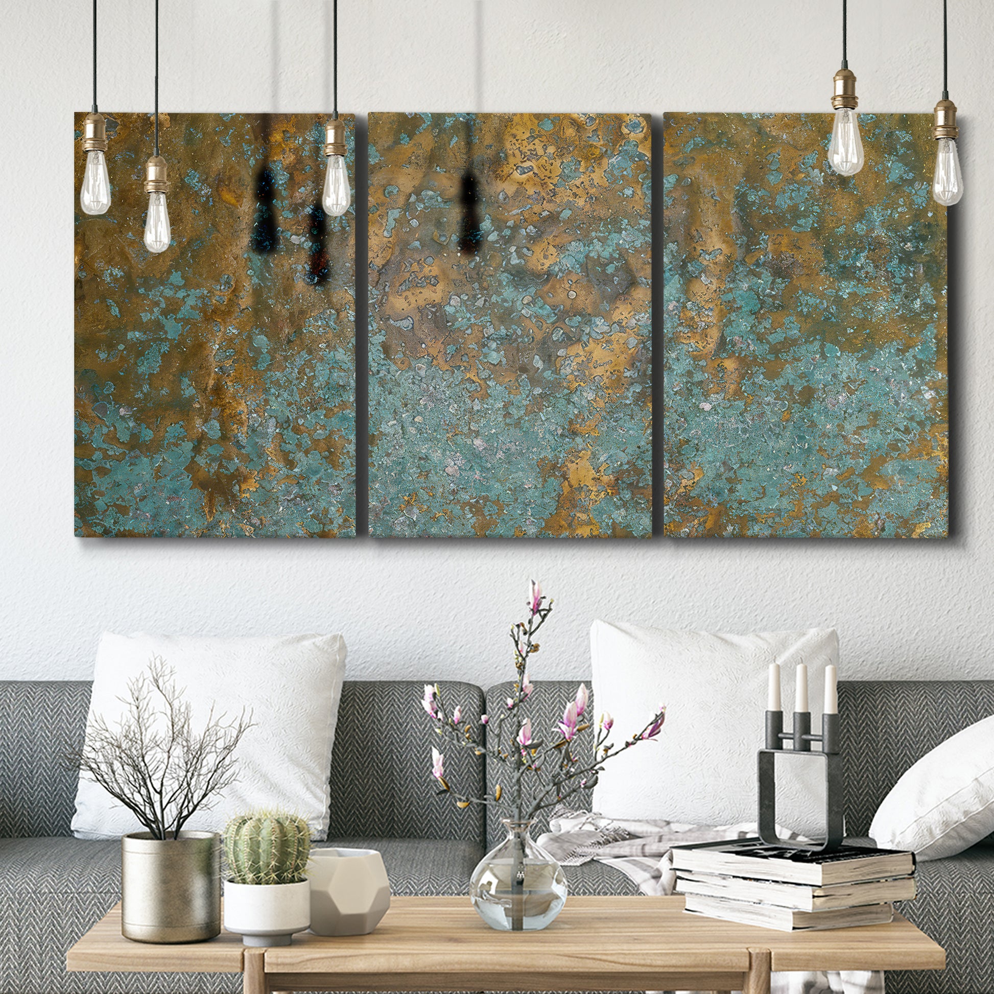 Three-panel canvas wall art featuring earthy copper toned abstract, displayed in a modern living room above seating.