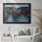 Impressionist rocky seascape by Claude Monet in an ornate black frame with gilded inner detail displayed in a bright interior setting.