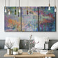 Three-panel canvas wall art featuring abstract evening landscape with depth, displayed in a modern living room above seating.